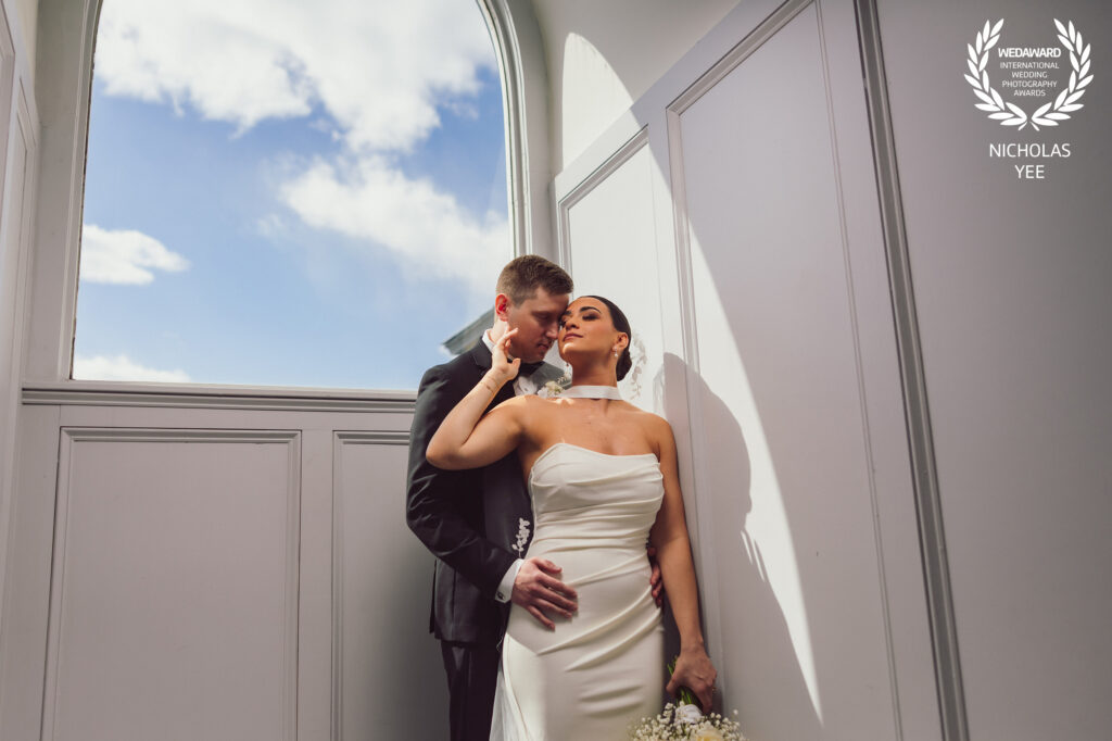 Intimate, romantic moment between a bride and groom under a beautiful natural light setting, expertly shot by an award-winning wedding photograph