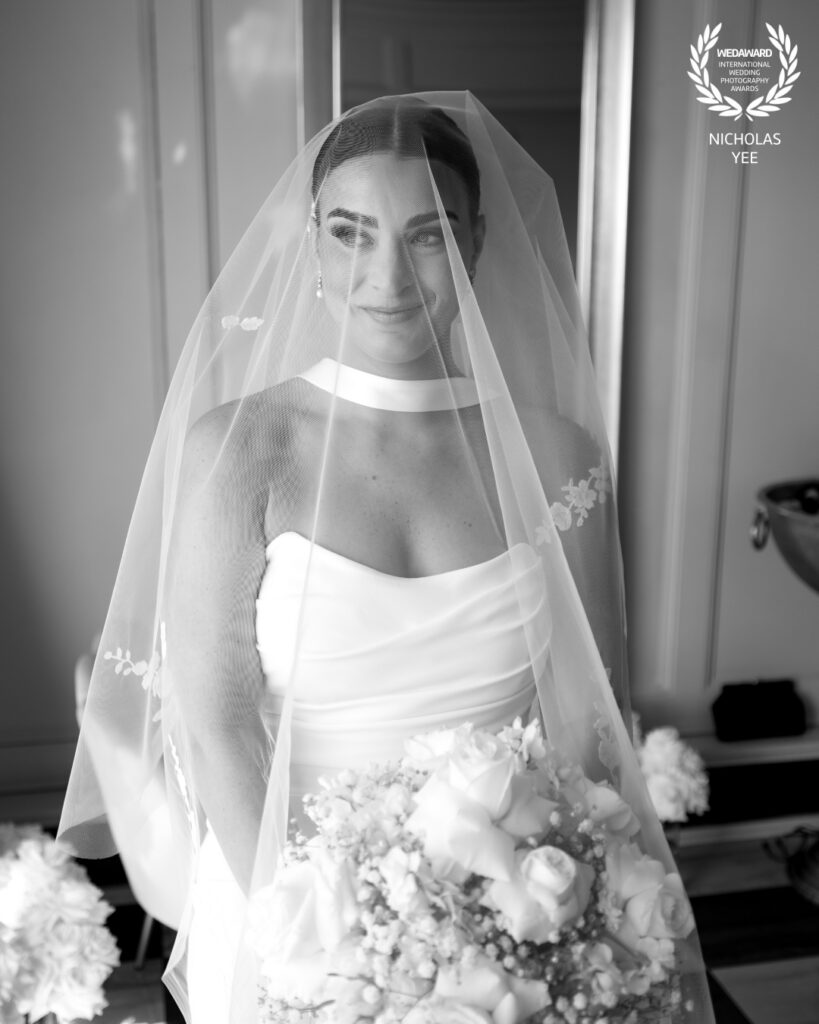 Black-and-white bridal portrait beneath a wedding veil photographed by award-winning New Jersey and Florida wedding photographer Nicholas Yee.